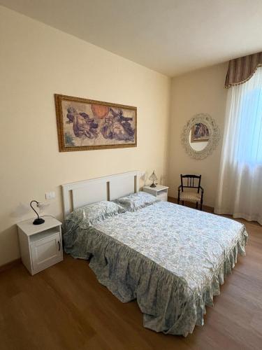 a bedroom with a bed and a picture on the wall at Le Magnolie 1924 in Casciana Terme