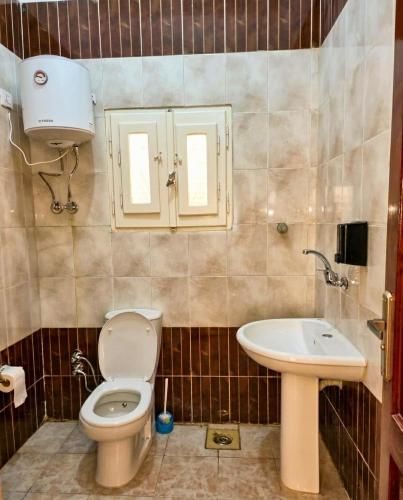 a bathroom with a toilet and a sink at شاليه العميد chalet in Marsa Matruh