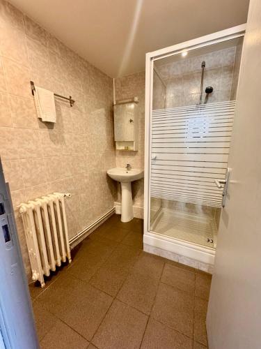 a bathroom with a shower and a sink at L’ESPERANCE in Versailles