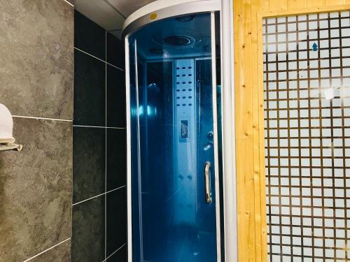 a shower with a blue door in a bathroom at Foyat Hotel in Addis Ababa