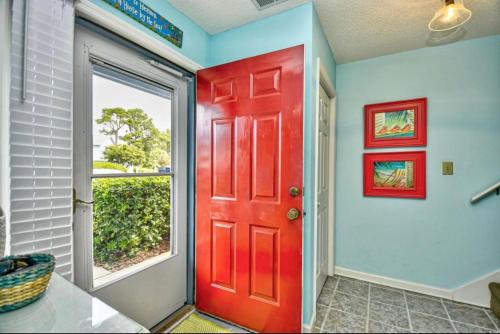 a red door in a room with a window at Nice N Myrtle beach house in Little River