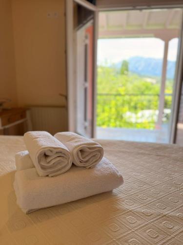 two towels sitting on top of a table at Xenia Apartments in Vasiliki