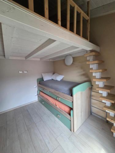 a small room with a bunk bed and stairs at Attico Casa ReGa - private parking and bbq in Quartu Sant'Elena