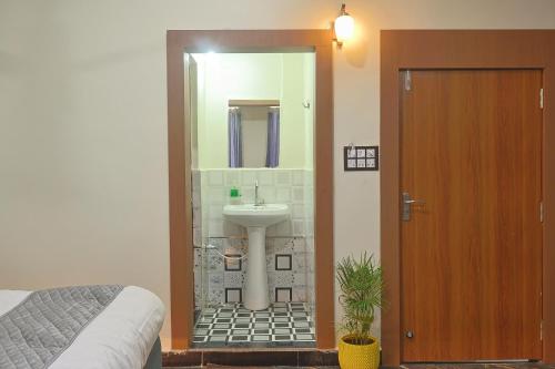 a bathroom with a sink and a mirror at Hotel Maharana Inn in Sehore