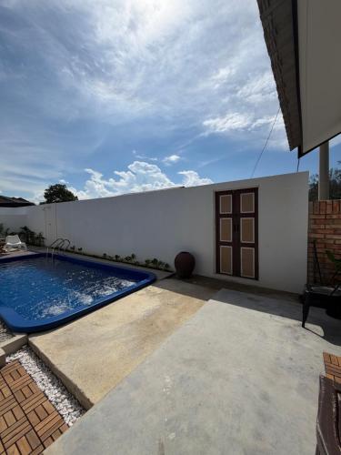 a swimming pool in the backyard of a house at Tamu Beradu Seaview Private Pool Villa in Dungun
