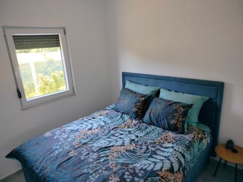 a bed in a bedroom with a window at Green Nest in Laktaši