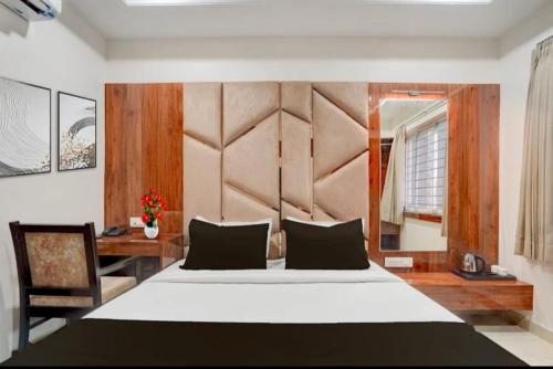 a bedroom with a large bed and a desk at Cross Lane- A Boutique Hotel-Kota in Kota