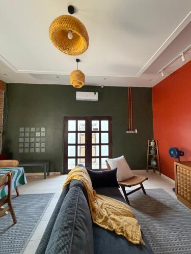 a living room with green and red walls and a couch at Tamu Beradu Seaview Private Pool Villa in Dungun