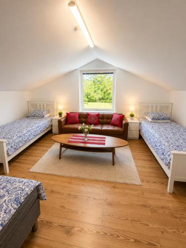 a living room with two beds and a couch at Nordic Home Finja in Hässleholm