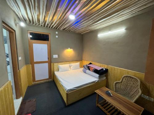 a small room with a bed and a table at Moon Lake Hotel, Nako in Nako