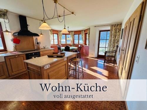 a kitchen with wooden cabinets and a kitchen island at VILLA SEEBERG - by "Schloss Gessenberg" luxurious vacation home with lake and mountain views, suitable for families and friends in Petting