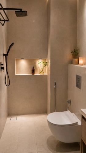 a bathroom with a white toilet and a sink at Seeq view in Sayq