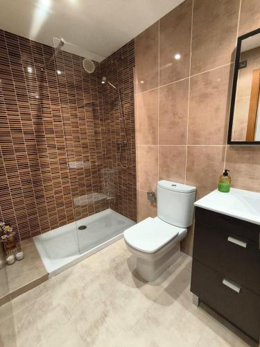 a bathroom with a toilet and a shower and a sink at Marzan Playa in Foz