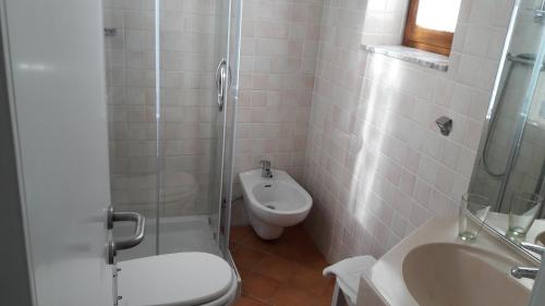 a bathroom with a shower and a toilet and a sink at Park Hotel San Michele in Martina Franca