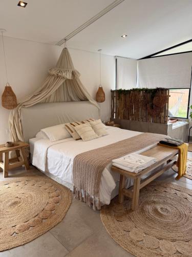 a bedroom with a large bed and a table at Alquimia House tu refugio en Santa Ana in Corrientes