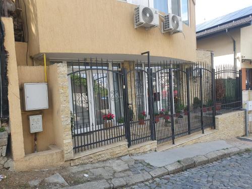 a building with a fence with a speaker on it at Casa Tim in Tulcea