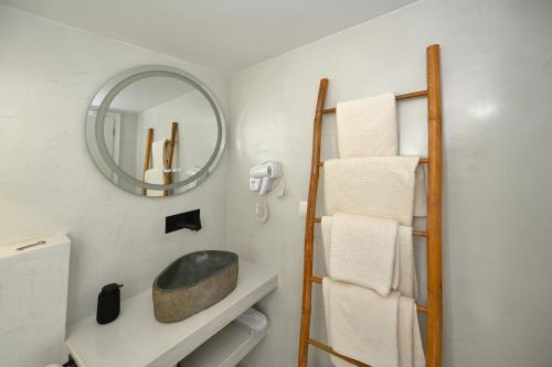 a bathroom with a mirror and a sink at kleris apartment 3 in Tinos