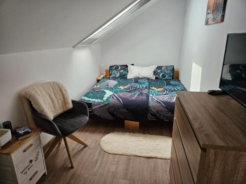 a bedroom with a bed and a chair in it at Vila RAMI in Donja Poljana