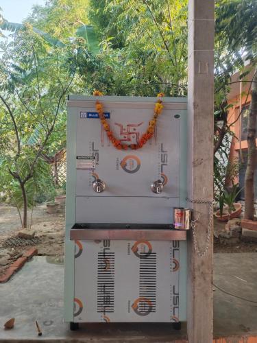 a machine is sitting next to a pole at Mauni Ashram in Prayagraj