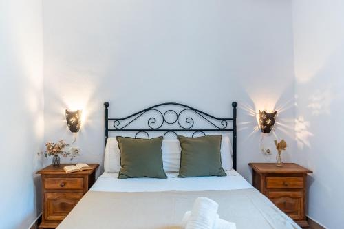 a bedroom with a large bed with two night stands at La Encina in Lanjarón