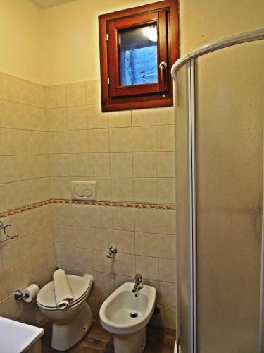 a bathroom with a toilet and a sink and a shower at Nonno Paco Vacanze in Casarza Ligure