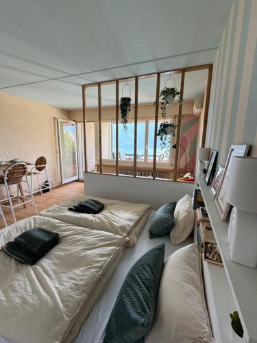 a bedroom with two beds with pillows on it at Ticino Lakeview Apartment in Bissone