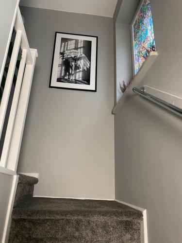 a stairway with a picture hanging on the wall at Przy Jeziorze in Złotów