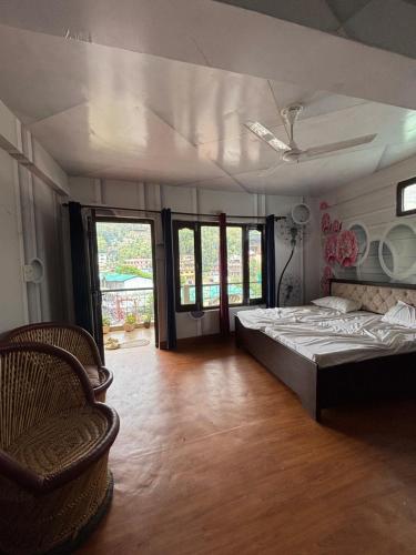 a bedroom with a bed and a chair in it at Ashirwad Homestay in Bhowāli