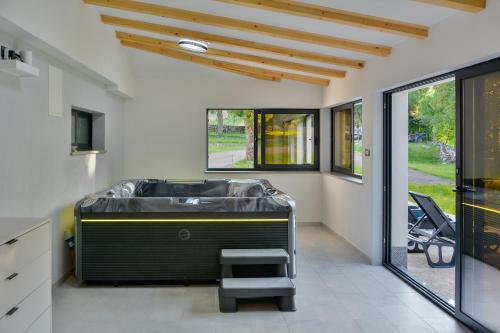 a room with a tub in the middle of a room at House MaLa in Senj