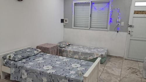 a room with two beds and a window at Casa céntrica de 2 dormitorios in Cañada de Gómez