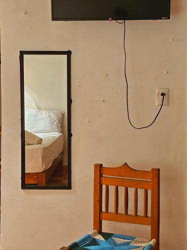 a mirror on a wall with a bed in a room at Casa Kal'i in Brisas de Zicatela