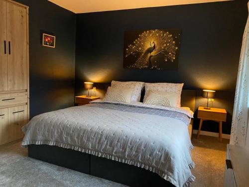 a bedroom with a bed and two lamps on tables at Przy Jeziorze in Złotów