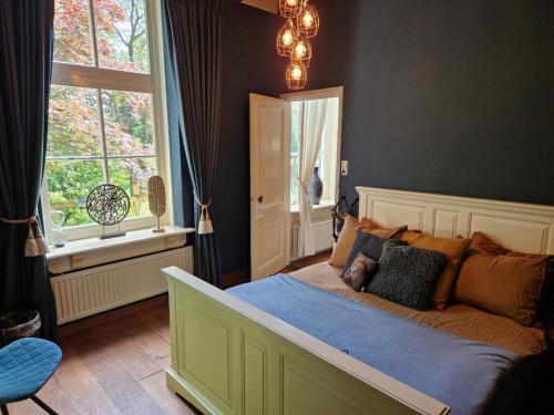 a bedroom with a large bed and a window at De Grote Belt in Oene