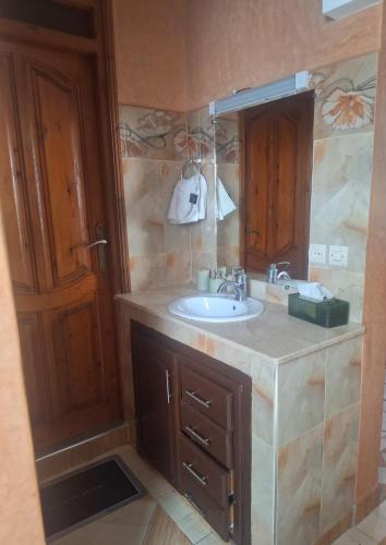 a bathroom with a sink and a mirror at Oasis Menara in Marrakesh