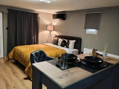 a bedroom with a bed and a table with pots and pans on it at Zen Lux in Zaječar