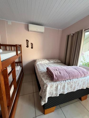 a bedroom with a bed and a bunk bed at Pousada da Igreja in Pântano Grande