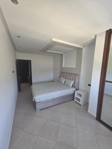 a bedroom with a bed in a white room at Apartment Stunning Panoramic View in Tétouan