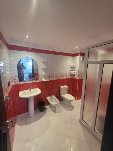 a bathroom with a sink and a toilet and a mirror at Apartment Stunning Panoramic View in Tétouan
