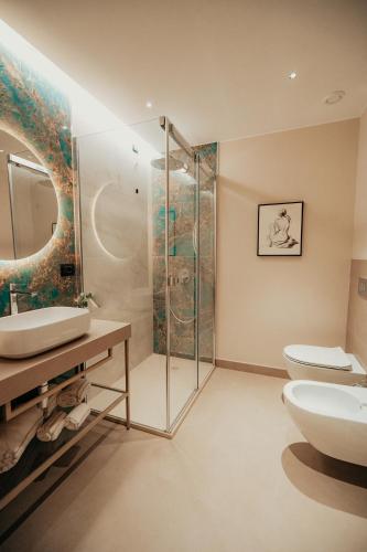 a bathroom with a sink and a toilet and a shower at Lumia Hotel in Termoli
