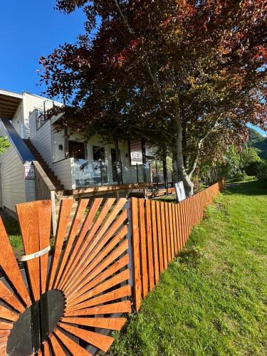 a wooden fence in front of a house at Strandheimen Guesthouse in Melhus