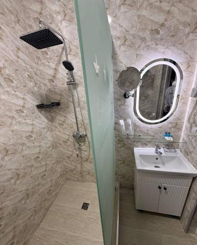 a bathroom with a sink and a mirror at Tinchlik Plaza in Urganch