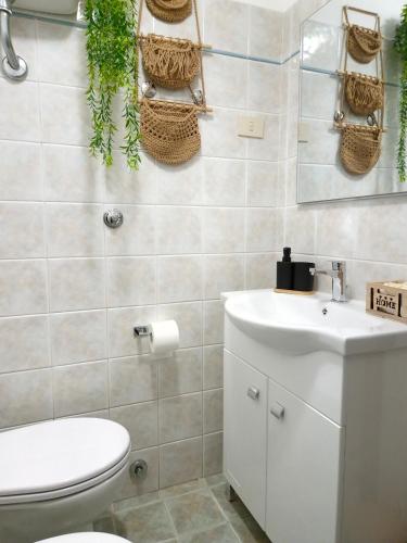 a bathroom with a toilet and a sink at Alloggio turistico borgo antico in Bagnaia