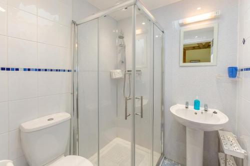 a bathroom with a shower and a toilet and a sink at 1 Bed in Falmouth oc-85594 in Constantine
