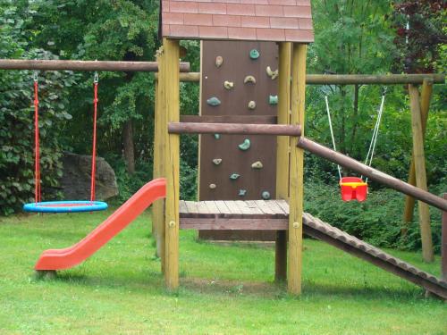 a playground with a slide and a climbing wall at Penzion Cabák in Vrchlabí