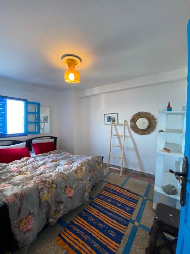 a bedroom with a bed and a ladder and a shelf at Soft Sand Beach in Taghazout