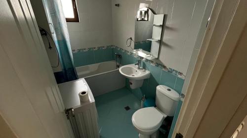 a bathroom with a toilet and a sink at Briz in Varna City