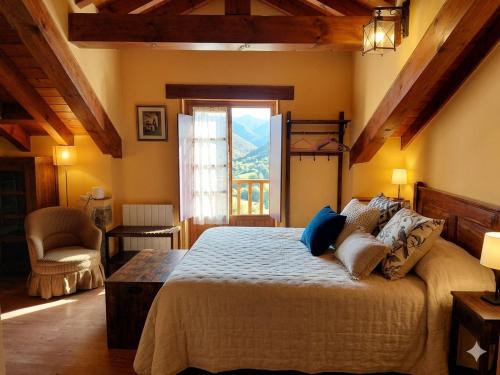 a bedroom with a large bed and a window at Posada Campo in Suances