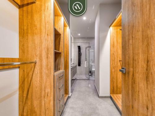 a hallway with wooden cabinets in a bathroom at Luxury Oceanfront 3 BR Condo with Balcony in Cruz de Huanacaxtle