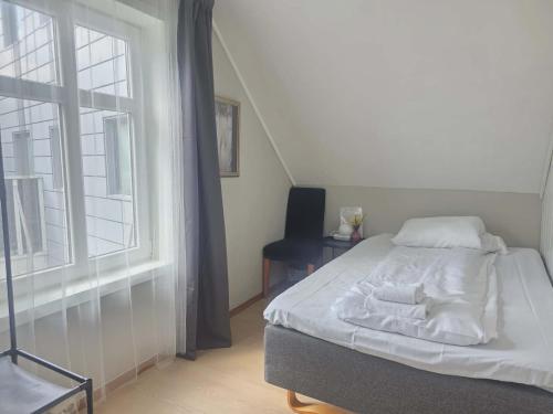 a bedroom with a bed and a window at Stavangerliving in Stavanger