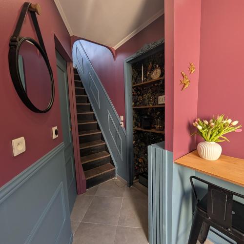 a hallway with pink walls and a wine cellar at Le Boudoir d'Héloïse in Breux Jouy